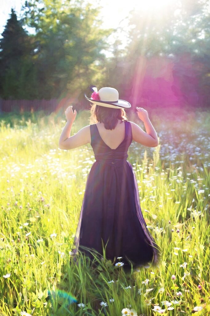 pretty woman in field, sunshine, long gown